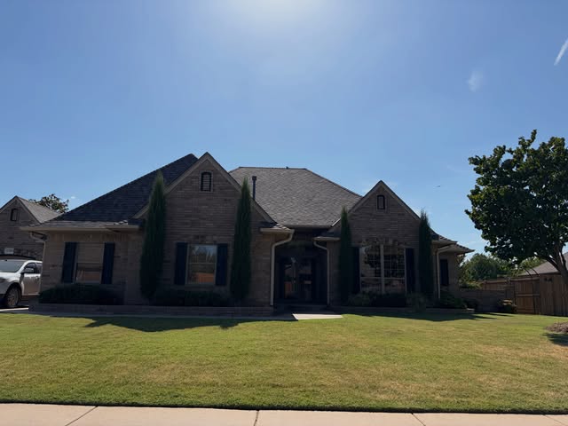 Brick ranch home with trimmed hedges, recent project