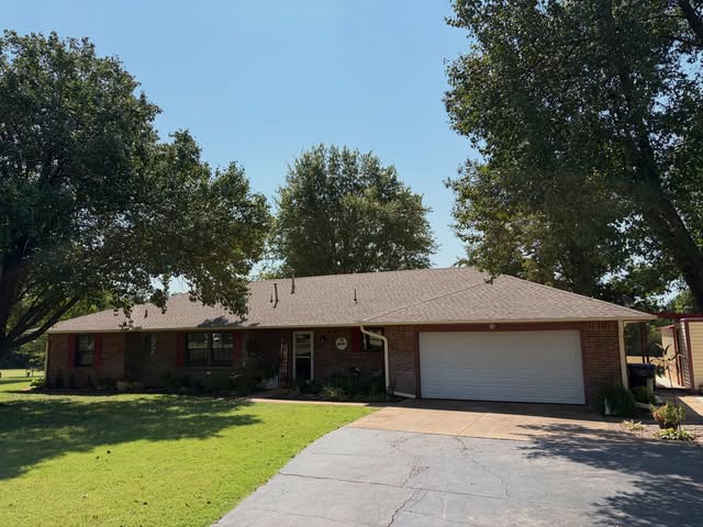 Single-story brick home with wide driveway, recent project