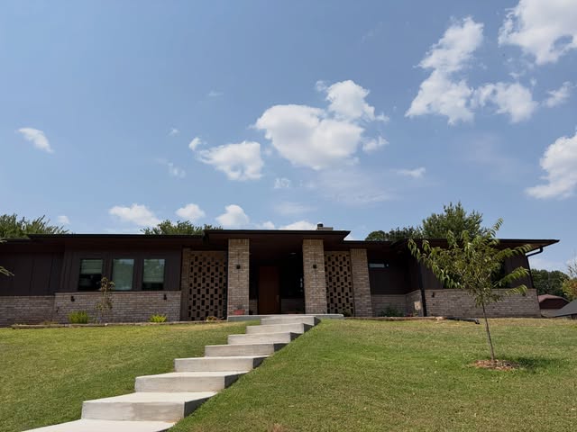 Modern home with stone columns and front steps, recent project