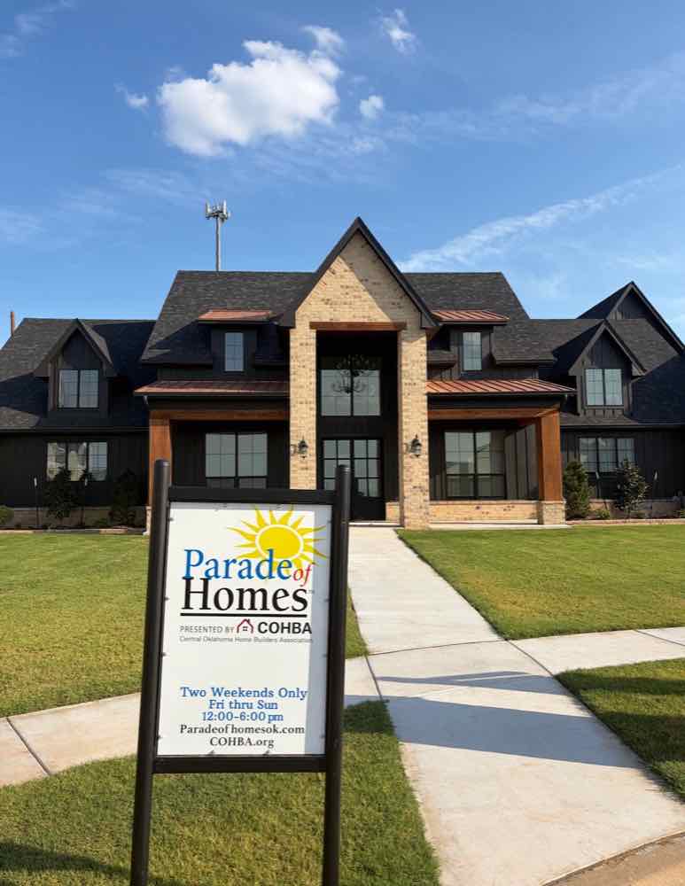 Custom showcase home with the official Parade of Homes sign presented by the Central Oklahoma Home Builders Association